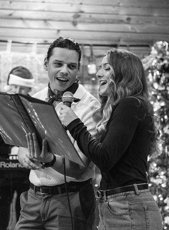 A man and a woman sing by Kyle Knitter