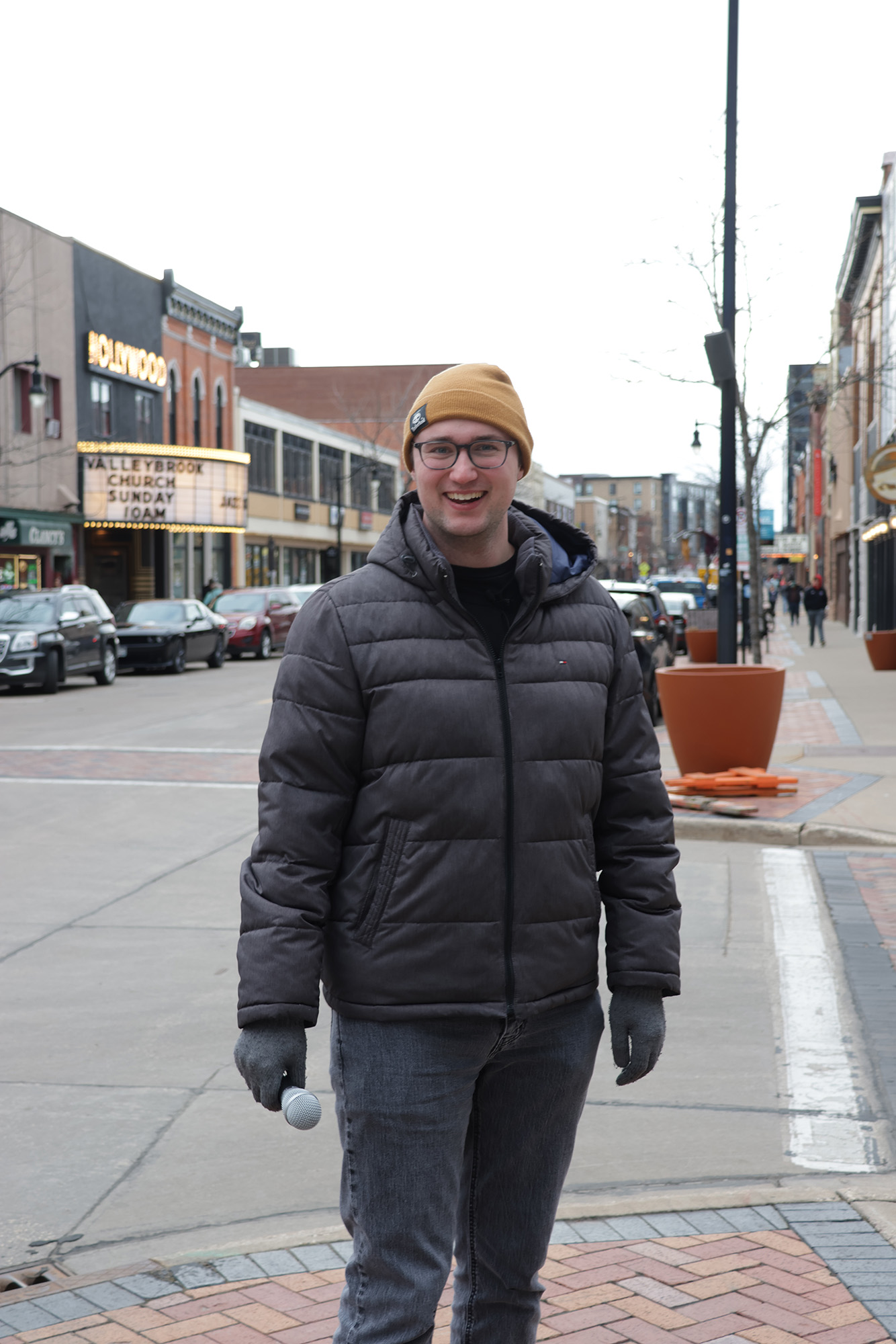 Kyle Knitter holding microphone, by Jay Tie